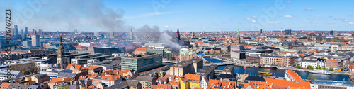 Smoke drifts over central Copenhagen as historic Copenhagen Stock Exchange burns down. Denmark