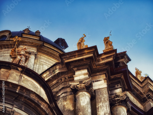 Religious Heritage: Ornate church exterior with sculptures and golden elements, captured on a bright day. The Dominican church and monastery in Lviv.