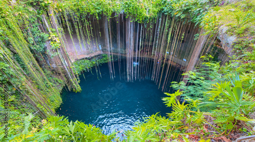 Amazing Ik-Kil Cenote sinkhole - Lovely cenote in Yucatan Peninsulla with transparent waters and hanging roots. Chichen Itza, Mexico
