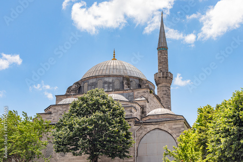 View of the dome and minaret of Gazi Atik Ali Pasha Mosque on a sunny day.