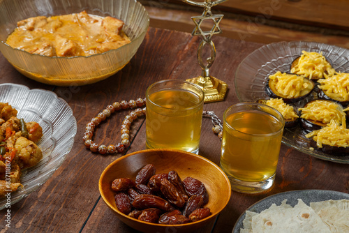Shabbat table for a family meal with traditional holiday dishes and drinks. Horizontal photo.