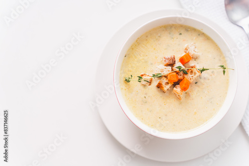 Cream soup of vegetables and cheese with croutons on a white table. A place to copy the space. Photo for a menu or banner. View from above.