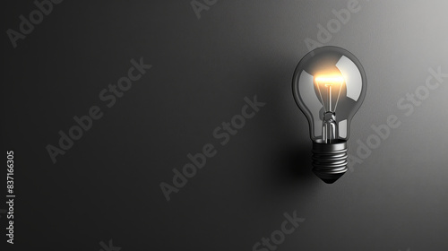 Illuminated light bulb against a dark gradient background, symbolizing creativity, innovation, and new ideas in a simple yet impactful way.