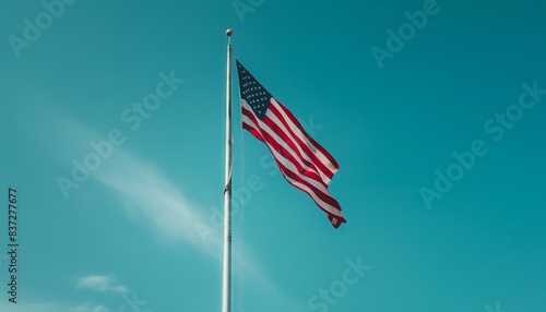 Flag of USA waving in the wind. Blue sky background.