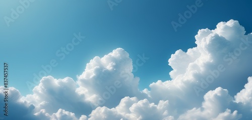 Fluffy cumulus clouds float in a tranquil blue sky, depicting the dynamic beauty of nature's canvas.