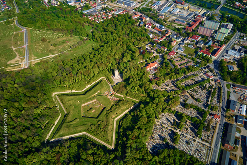 Aerial view of Prusy Fort in Nysa city on clear day, Star-shaped historical military fortress surrounded by lush greenery and the town in background. Tourist attraction in Poland