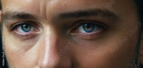 An evocative close-up of a person's face focusing on the deep blue eyes, expressing intensity and depth.