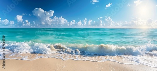 Sunny beach paradise with turquoise waves lapping the shore under a clear blue sky
