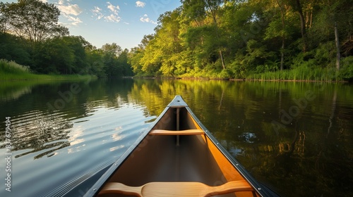 This image features a canoe on a calm river with lush greenery and sunlight filtering through trees
