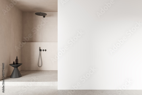 Beige hotel bathroom interior with douche, accessories and mockup wall