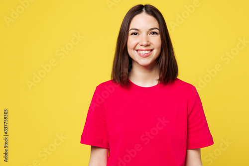 Young smiling happy cheerful satisfied fun cool student woman she wear pink t-shirt casual clothes looking camera isolated on plain yellow orange color background studio portrait. Lifestyle concept.