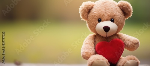 Teddy Bear Holding a Red Heart Outdoors