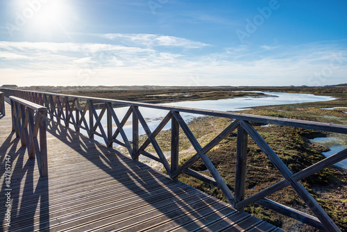 Landmark footbridge heading to famous Quinta do Lago beach, in Ria Formosa wetlands, Algarve. Portugal