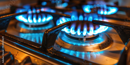 Close-up shot of blue fire in domestic kitchen stovetop. Gas cooker, burning flames. Propane gas resources concept