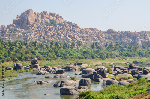 Natural scenery of Tungabhadra river. Tourist places. Mountain of huge stones. Unesco World Heritage town Hampi, Karnataka, India, Asia.