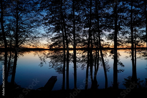Sunset over lake with trees at shore