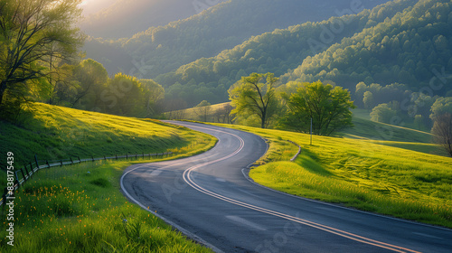 Sunlit county road meandering through a green mountain landscape, surrounded by lush trees and rolling hills, creating a serene and scenic view.