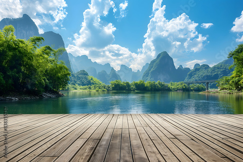 Wooden floor, large wooden boardwalk with a beautiful view landscape and blue sky with white clouds in the background. 