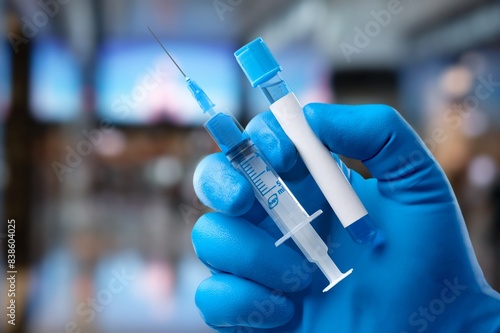 Medical worker filling a syringe with vaccine booster