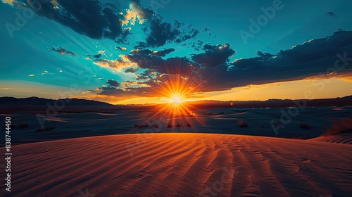 Tranquil and serene majestic desert sunset over the sand dunes with dramatic and warm golden hour colors. 