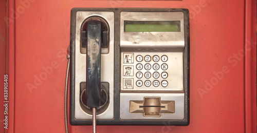 Old public phone on the city street.