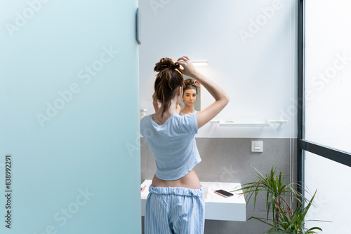 Rear view of young woman in bath room