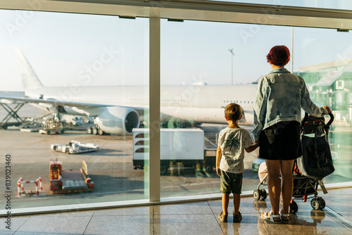 Spain, Barcelona airport, Mother and son waiting in departure area