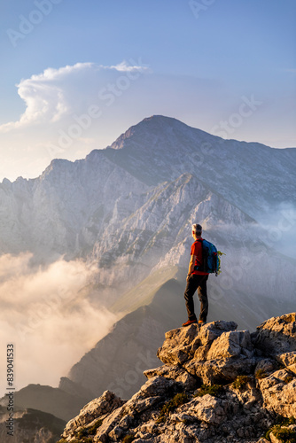 Hiker standing while admiring view of mountain at Bergamasque Alps, Italy