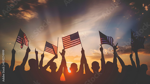America celebrates the 4th of July. Patriotic. Silhouettes of people holding the Flag of the USA.