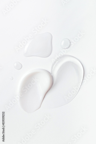 samples of cosmetic care products smear of cream and gel texture on a light background