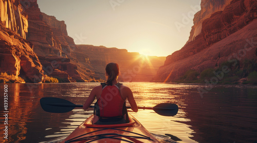 A solo kayaker paddles through a serene canyon river at sunrise, surrounded by majestic cliffs and warm golden light. 