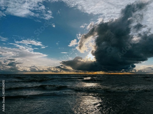 sunset after rain in leningrad region, finnish bay and fantastic clouds at sunset