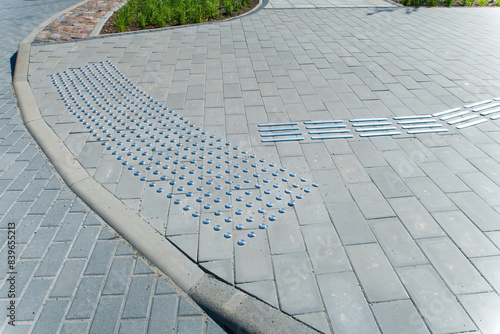 Sidewalk for the visually impaired. Metal blocks of tactile covering for blind people with disabilities.