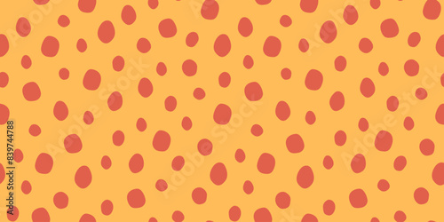 Bright seamless spotted pattern. Vector print from animal skin. Colorful illustration in yellow and orange colors. Hand-drawn figures in flat style.