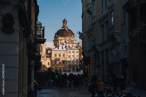 View of the historical center of Lviv, Rynok Square from the side of a narrow lane. Dominican Cathedral in the rays of the evening sun.