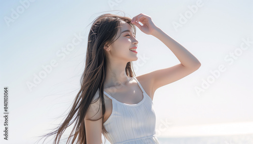 ナチュラルメイクの笑顔のロングヘアの日本人の女性の夏のイメージ,旅行,美白,美容 上半身