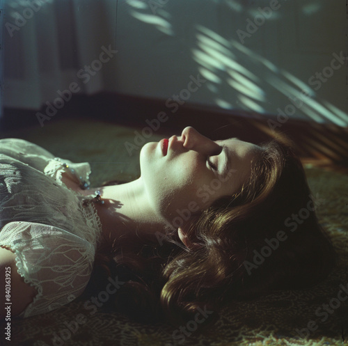 color photo close up of a young woman's face in 1966 laying on her back, hair fanned out around her head, lips slightly parted, looking at the camera