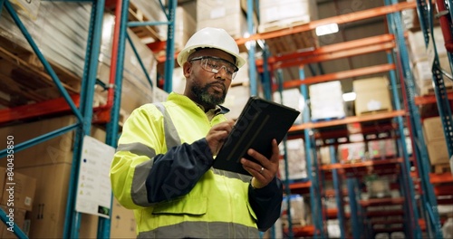 Warehouse, black man and manufacturing with tablet, inventory and checklist in a factory. African person, worker and employee with tech and inspection with digital app for logistics and online stock
