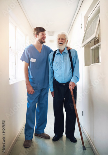 Support, healthcare and caregiver with senior man in hallway with help, hug or bonding. Homecare, walking and nurse embrace old patient with disability, recovery or physical therapy progress