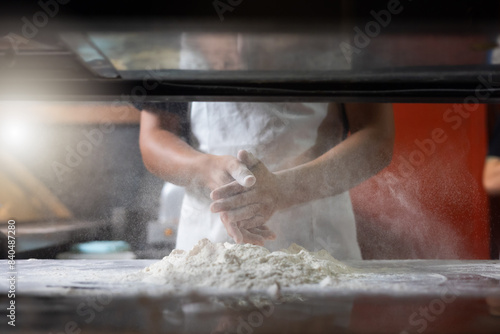 experienced chef - Professional chef prepares the dough with flour to make pizza or pasta Italian food