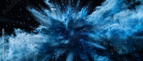 An intense explosion of blue powder, frozen in time, captures the vibrant motion and dynamic energy of the particles bursting outward.