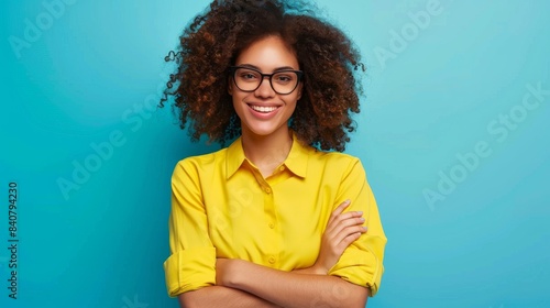 Photo of attractive curly business lady hold hands crossed toothy beaming smiling best chief worker wear yellow shirt trousers isolated blue color background