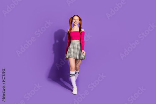 Full length photo of pretty attractive lady dressed off shoulders top smiling walking empty space isolated violet color background