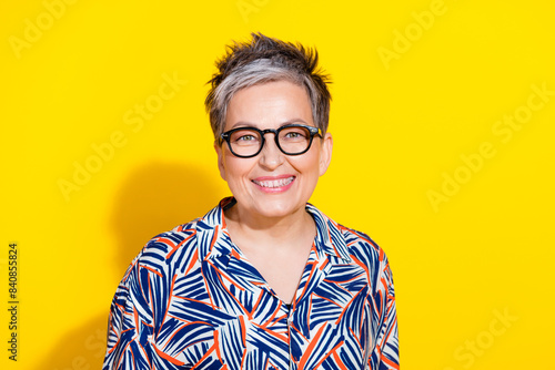Photo of nice aged lady beaming smile empty space wear shirt isolated on yellow color background