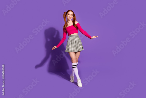 Full length photo of cheerful pretty lady dressed pink top walking empty space isolated violet color background