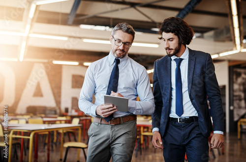 Business people, tablet and talking or walking in office with discussion for project management and client briefing. Manager, employee and networking with digital tech for teamwork on corporate ideas