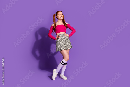 Full length photo of lovely young lady posing model look empty space dressed stylish pink garment isolated on violet color background