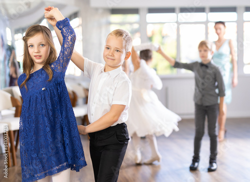 Children dance in pairs at a festive matinee