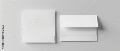 Top view of blank white notepad and envelope set on grey background for stationery or branding mockup.
