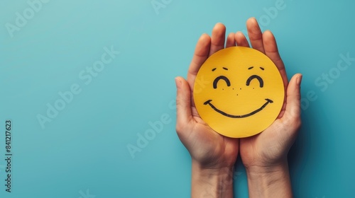 Happy Emoji Illustration on Blue. A cheerful yellow emoji with a broad smile and rosy cheeks, presented on a vivid blue background.